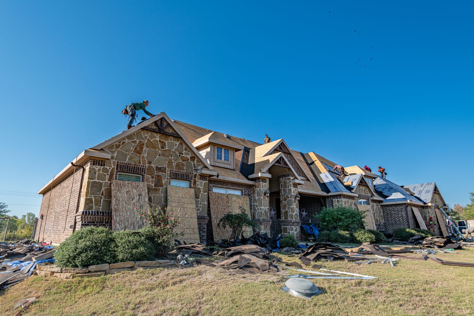 Brick house undergoing roof installation