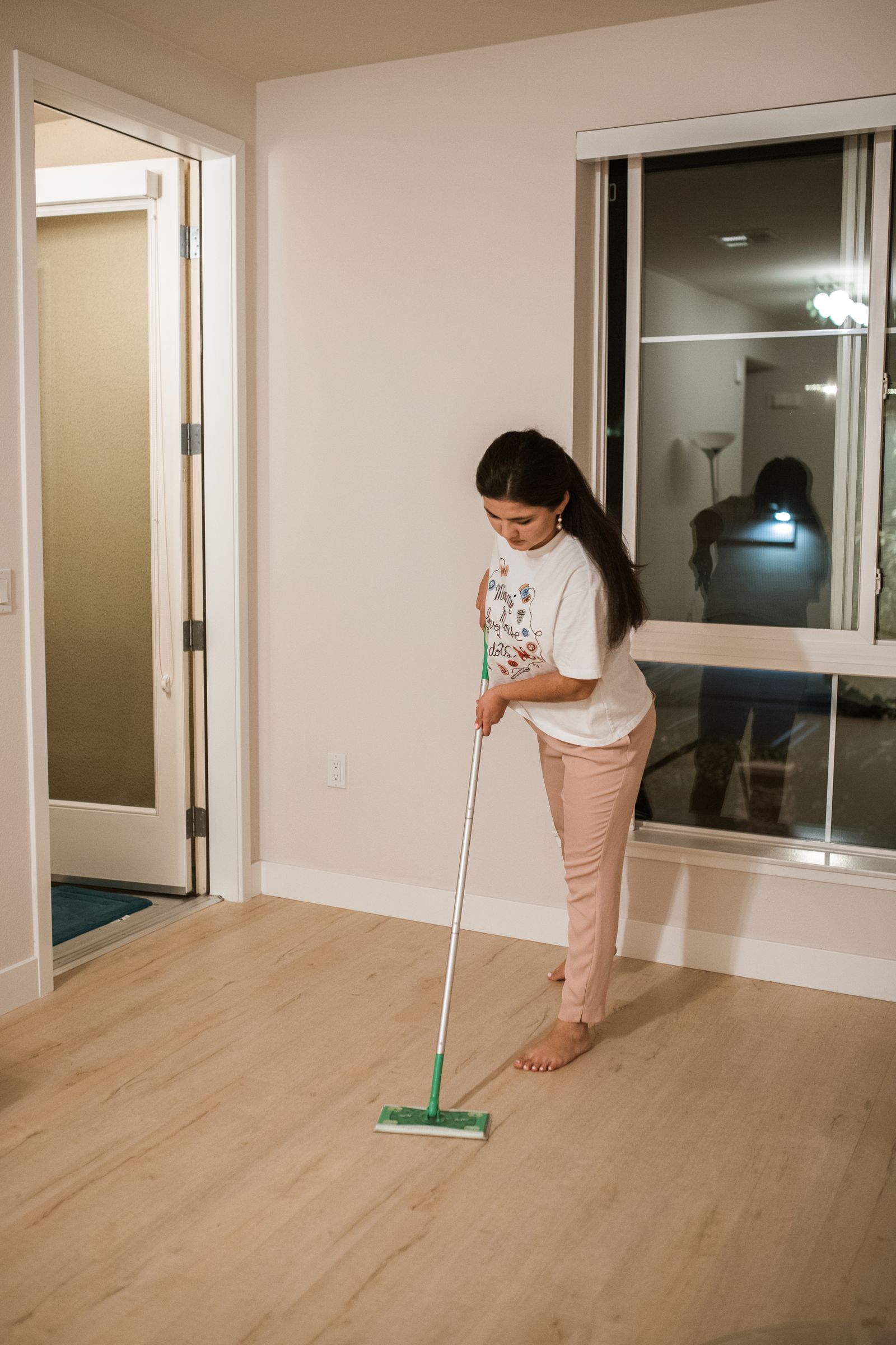 Person mopping a hardwood floor