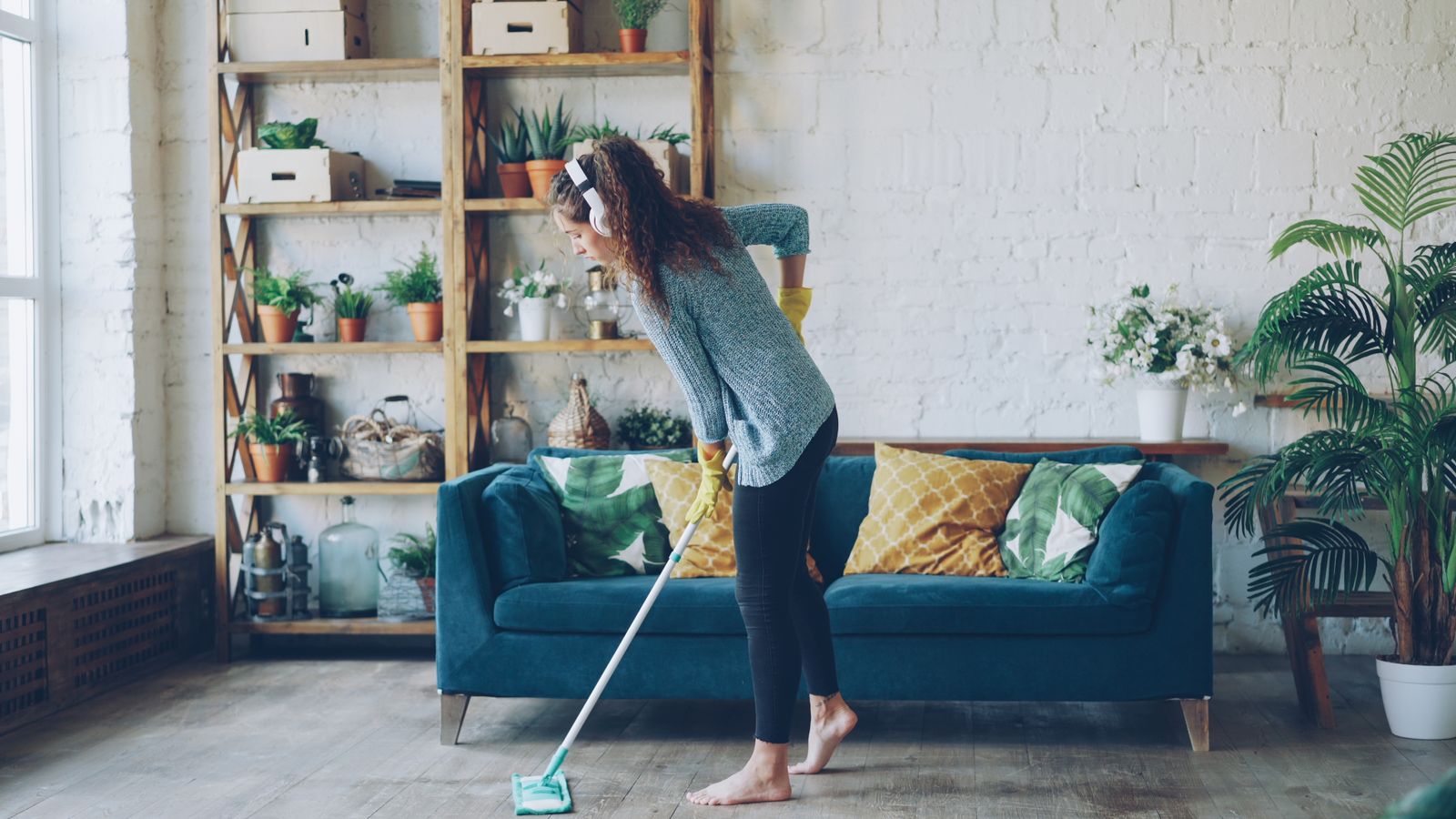 Woman mopping a living room